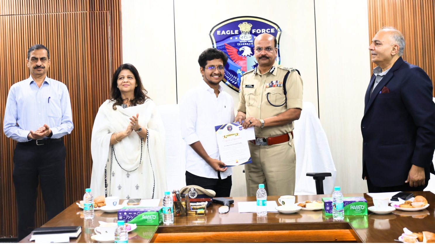 Praneeth receiving a certificate from Shri B. Shivadhar Reddy, IPS, Director General of Police, Telangana, in front of the EAGLE Force emblem